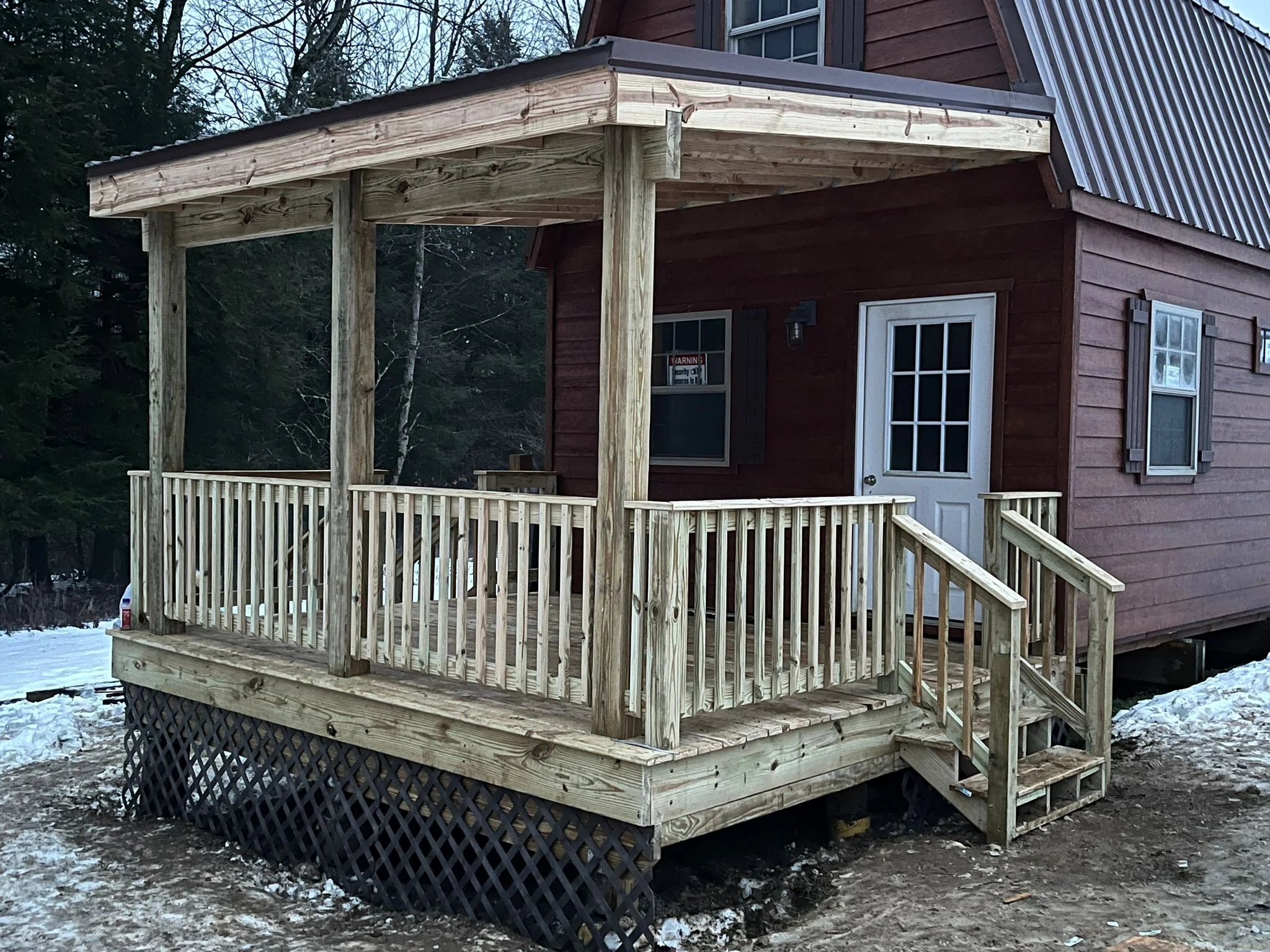 Screened porch with spindle railings, large windows, metal roof, and attached deck stairs, Vestal NY