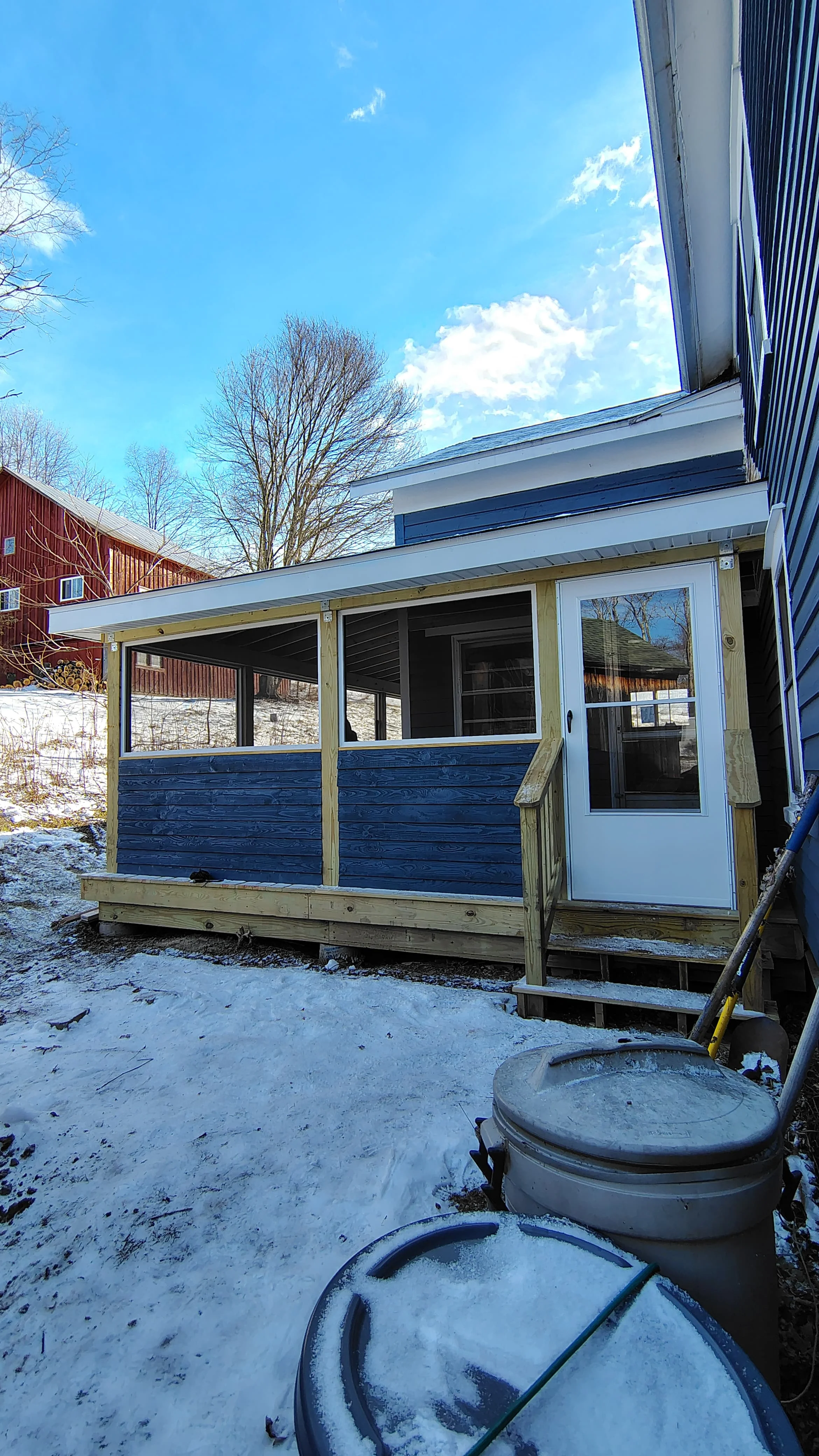 Screened porch with blue wood siding, standing seam metal roof, and multi-pane windows, Vestal NY
