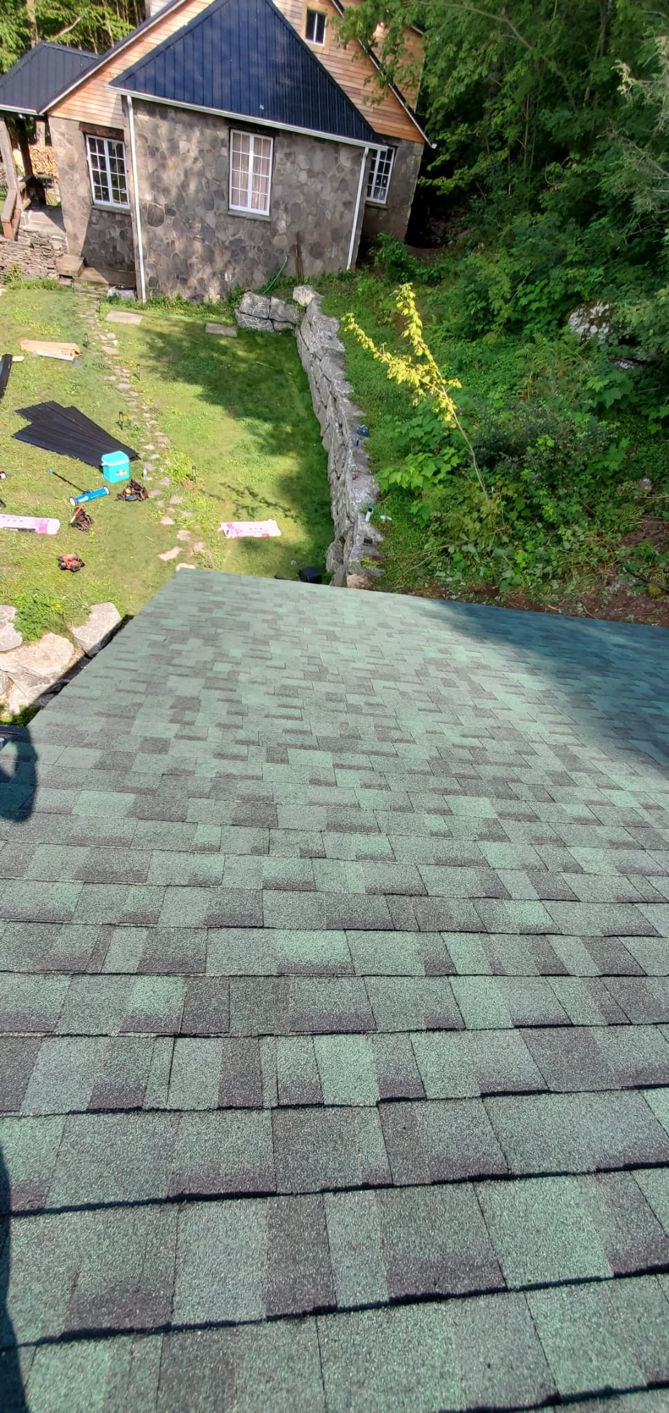 New architectural shingle roof with gray and charcoal dimensional shingles installed in offset pattern
